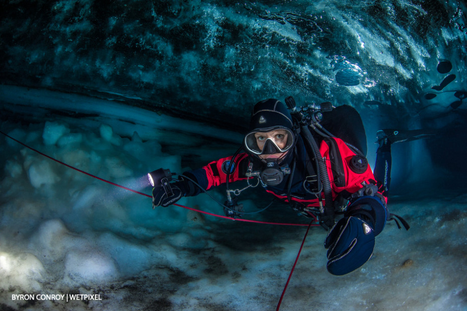 A model poses in an ice cave.