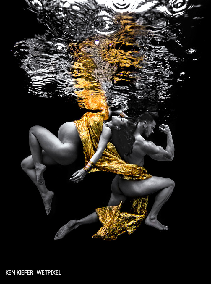 Underwater maternity couple shot on a black backdrop., double the models, double the effort to achieve certain looks.