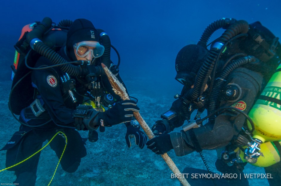 Technical divers Phil Short and Alexandros Sotiriou examine the bronze spear at 53 meters prior to recovery.